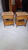 Front view showing two Kroehler bedside tables side by side with drawers and lower shelves.