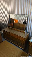 Front and overhead view of the Kroehler mid century modern dresser with laminate surface and mirror showing the overall design and condition.