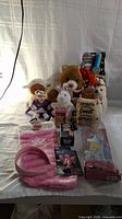 Full lot display showing assorted stuffed animals, Cinderella doll in box on the right, princess Christmas stocking, pink fuzzy slipper socks, and small packaged toys in front