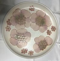 Top side of Denby Gypsy platter showing pink and green flower design with clusters of rose dots on cream background.