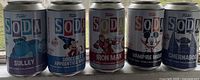 Front view of five Funko Soda cans showcasing the characters Sulley, Sorcerer's Apprentice Mickey, Iron Man, Vampire Mickey, and Chernabog.