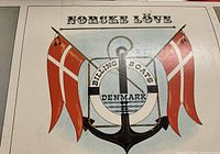 Box top showing logo: Norske Løve Billing Boats Denmark with anchor and red flags design.