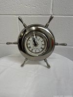 Front view of the marine steering wheel tiller clock showing the clock face and chrome finish.