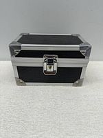 Closed luxury black and silver lockable storage case with lock and keyhole visible.