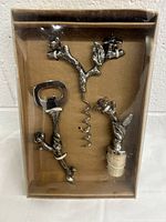 Photo showing the three-piece set arranged inside a clear plastic and cardboard box, displaying all items and their decorative details.