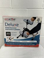 Box front of Proactive Deluxe Pedal Exerciser showing product in use with feet on pedals and LCD screen visible