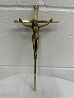 Front view of vintage brass crucifix cross with detailed Jesus Christ figure mounted on cross.