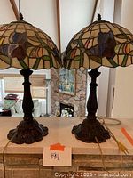 Pair of lamps on countertop showing full height and proportion with vaulted ceiling background