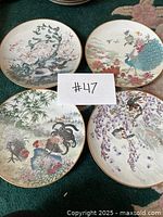 Overview of all four plates arranged on carpet with lot identifier