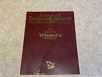 Dark red softcover book cover with gold embossed title text and TSR logo.