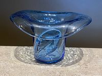 Front view of the vintage blue hand blown glass cowboy hat shaped toothpick holder with wide, rounded brim and cylindrical base