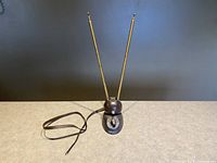 Front view of the Channel Master rabbit ears TV antenna showing the extendable metal rods and base with power cord visible.