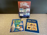 Photo showing all three collectible reference books arranged on a tabletop, highlighting their covers.