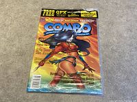Front photo of Combo Magazine Issue 31 sealed in plastic with female character on cover