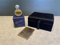 Full lot showing velvet photo album, Royal Doulton perfume bottle in its box, and gold-tone compact mirror.