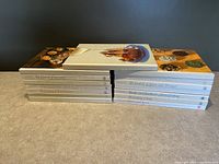 Set of nine "Foods of the World" hardcover cookbooks by Time-Life laid out in two stacks, showing the book titles on the spines.