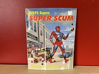 Front cover of GURPS Supers: SUPER SCUM source book by Steve Jackson Games. Shows superhero character illustration and title.