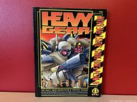 Front cover of the Heavy Gear Rulebook showing mech artwork and title text.