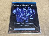 Front cover of limited edition sealed hockey yearbook showing Toronto Maple Leafs players with Stanley Cup 1961-1962.