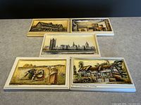 Full group of five Ivorex Osborne wall plaques showing detailed scenes and arrangement of all plaques.