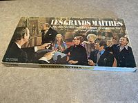Top of game box with vintage auction artwork and title 'Les Grands Maitres'