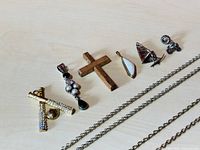 Close-up of all six pendants showing detailed design elements including rhinestones, wood grain, and shapes.