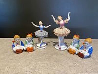 Full lot of Kouwa ballerina figurines and salt and pepper shakers shown arranged on surface.