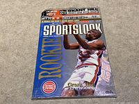 Front cover of the March 1995 NBA Hoops Sportslook magazine featuring Grant Hill in Detroit Pistons uniform, with 'ROOKIE' in large letters and magazine title.