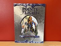 Front cover of 'Points of Light II, The Sunrise Sea' showing title, artwork of fantasy characters.