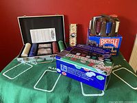 Overview of poker set including felt mat, chip sets in boxes, chip case, and revolving chip rack.
