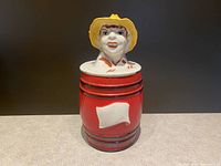 Front view of the complete vintage ceramic canister with farm boy lid from Regal China