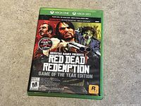 Front cover of Red Dead Redemption Game of the Year Edition Xbox game case showing artwork, title, and compatibility