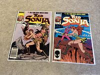 Both Red Sonja comic issues side by side on a surface, showing front covers.