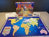 Full game set laid out on table showing the board, box, and instruction sheets.