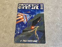 Front cover of Starfire II game manual with space battle artwork and title.