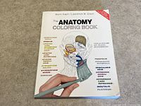 Front cover of The Anatomy Coloring Book showing detailed anatomical illustration and text