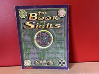 Front cover of The Book of Sigils Castle Falkenstein RPG book showing title, artwork, and condition.