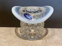 Front view of vintage Fenton hobnail top hat toothpick holder with moonstone opalescent brim, showing Fenton label.