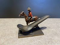 Side view of the RCMP mountie on horse pipe holder showing pipe rest and painted details
