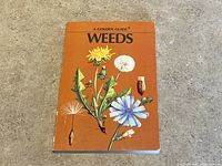 Front cover of the Golden Guide 'Weeds' showing botanical illustrations on orange background.