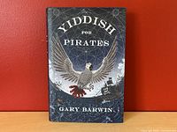 Front cover of 'Yiddish for Pirates' showing the title, author, and artwork including a prominent bird and pirate elements.