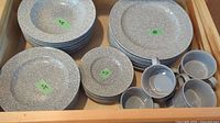 Drawer view showing stacks of dinner plates, salad plates, bowls and mugs