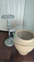 Photo showing both the silver painted wood side table and the ceramic table with glass top together