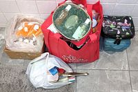 Overview of multiple bags containing beauty aids and care products, with visible bottles and boxes.