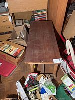 Top view of the rectangular wood coffee table showing surface scratches and front edge damage.