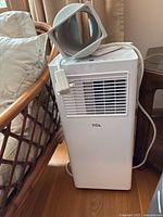 Full view of TCL portable air conditioner unit with exhaust hose attachment and power cord.