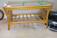 Full view of rattan side table showing the glass top and lattice sides "front angle".