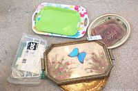 Photo of party trays including green, floral, octagonal with butterfly, rustic apple design, and paper towels.