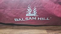Red storage bag with white Balsam Hill logo