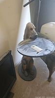 Full view of composite and wood hound dog table holding round tray